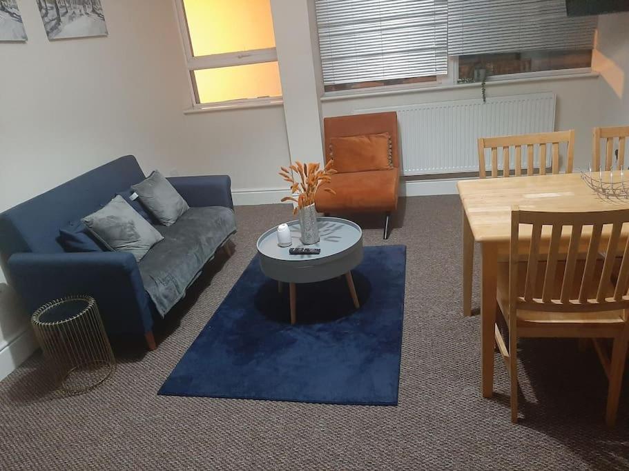 a living room with a couch and a table at Spacious. Contractors. Brierley in Brierley Hill