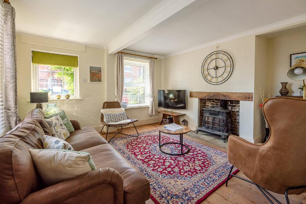 sala de estar con sofá y chimenea en Abigail's Cottage Air Manage Suffolk en Woodbridge