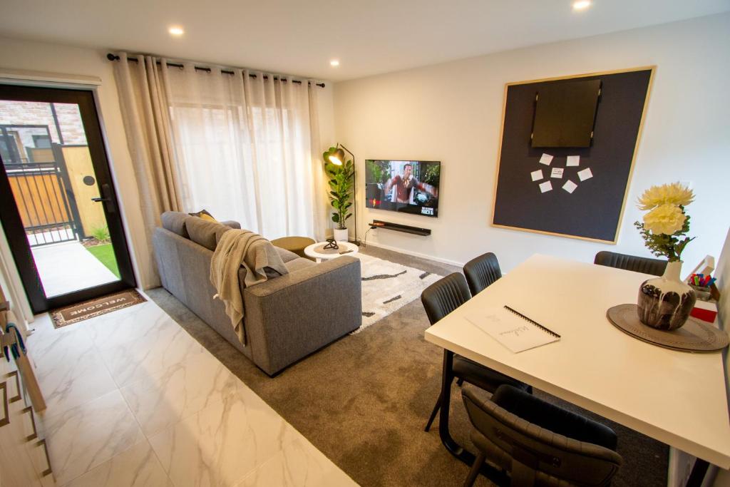 a living room with a couch and a table at A touch of Luxury in Chch CBD in Christchurch