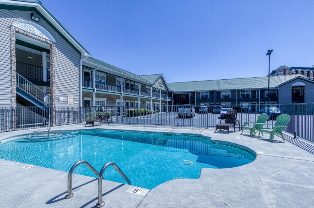 a swimming pool in front of a building at Colonial Crest 110 - Great location! - You can walk to town! condo in Pigeon Forge