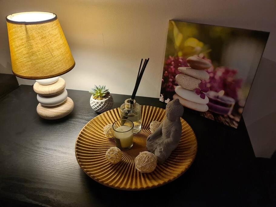 una mesa con un plato de comida y una lámpara en Gîte Zen, en Carnoules