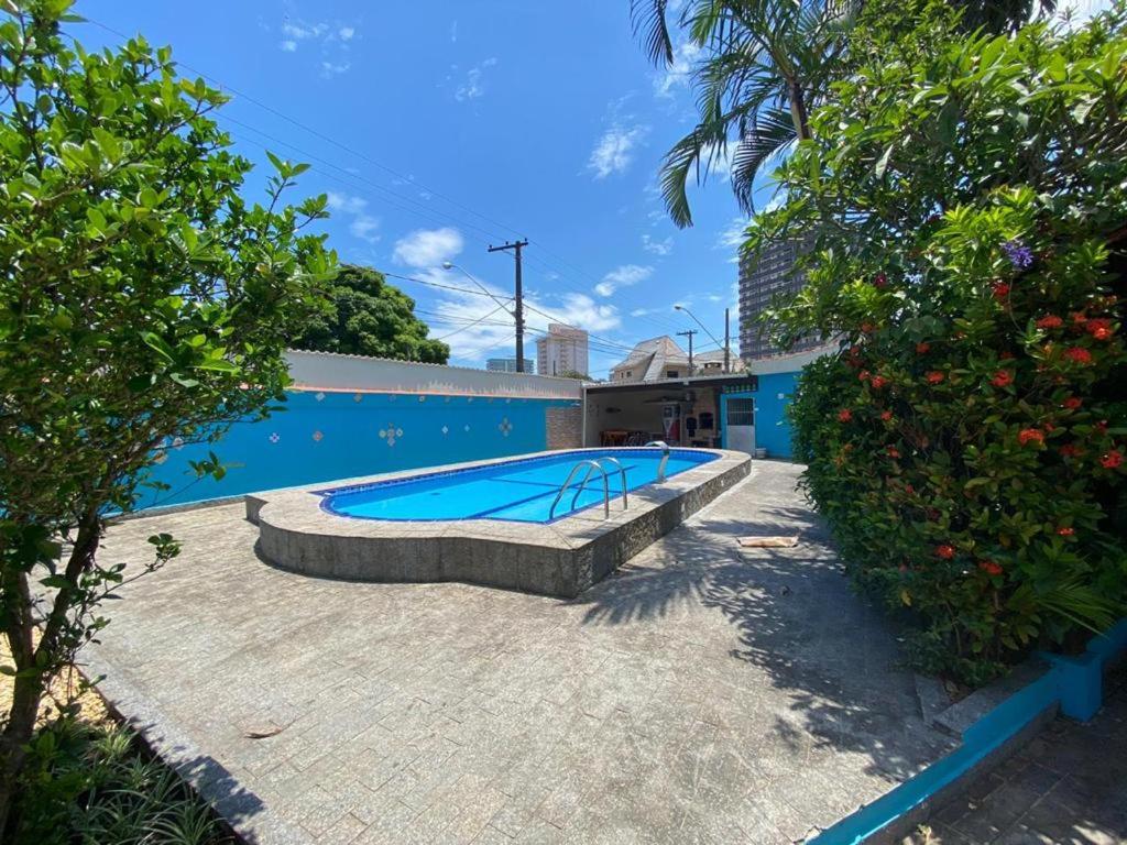 uma piscina em frente a um edifício em Casa com Piscina Canto do Forte - Praia Grande na Praia Grande