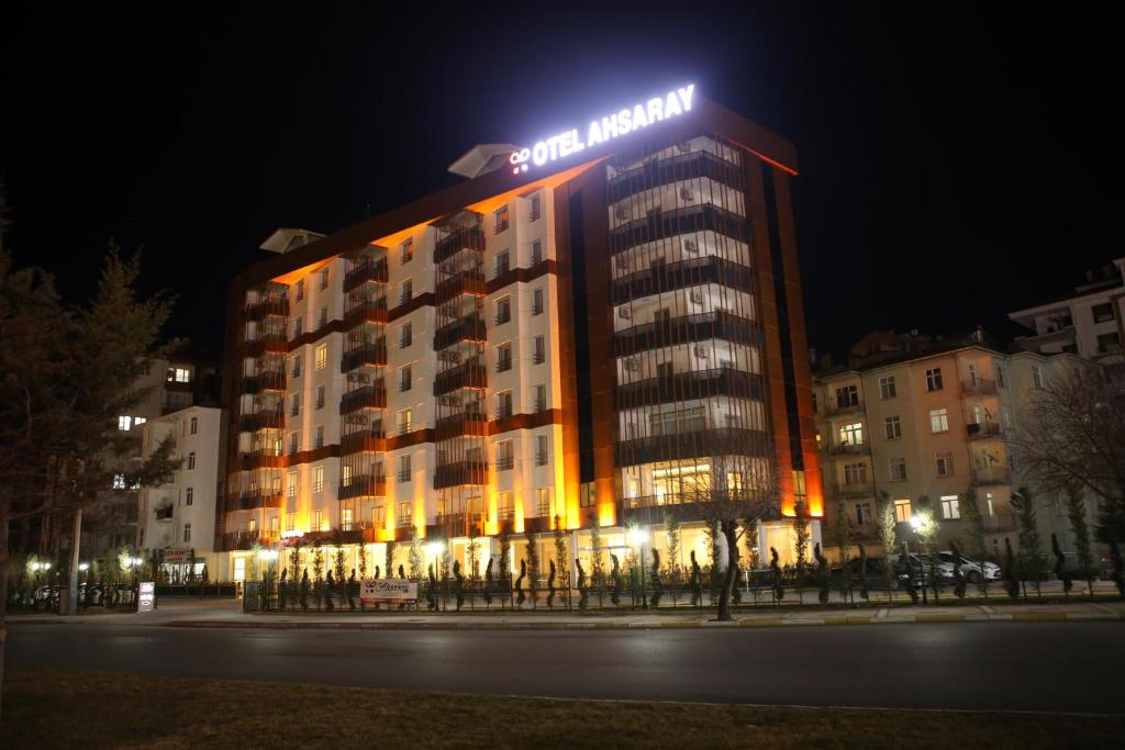 a building with a sign on top of it at night at Ahsaray Hotel in Aksaray