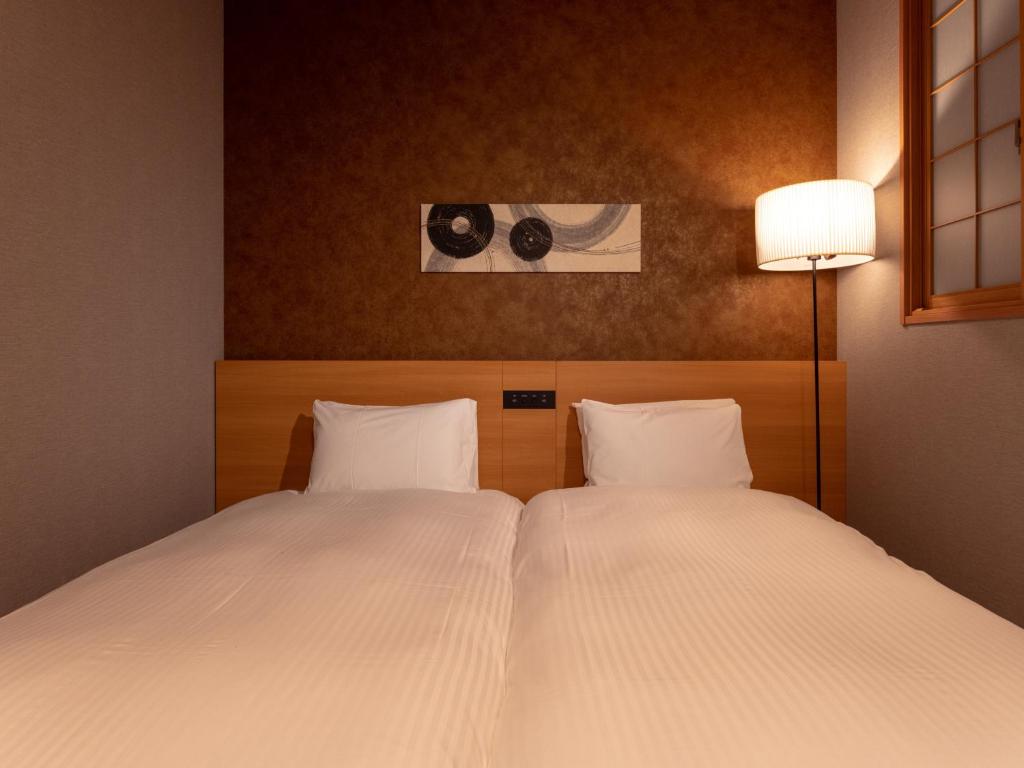 Postel nebo postele na pokoji v ubytování MIMARU SUITES Tokyo Asakusa