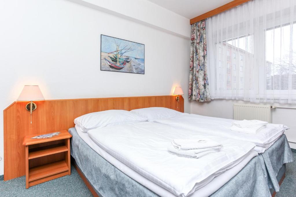 Postel nebo postele na pokoji v ubytování Hotel Astra