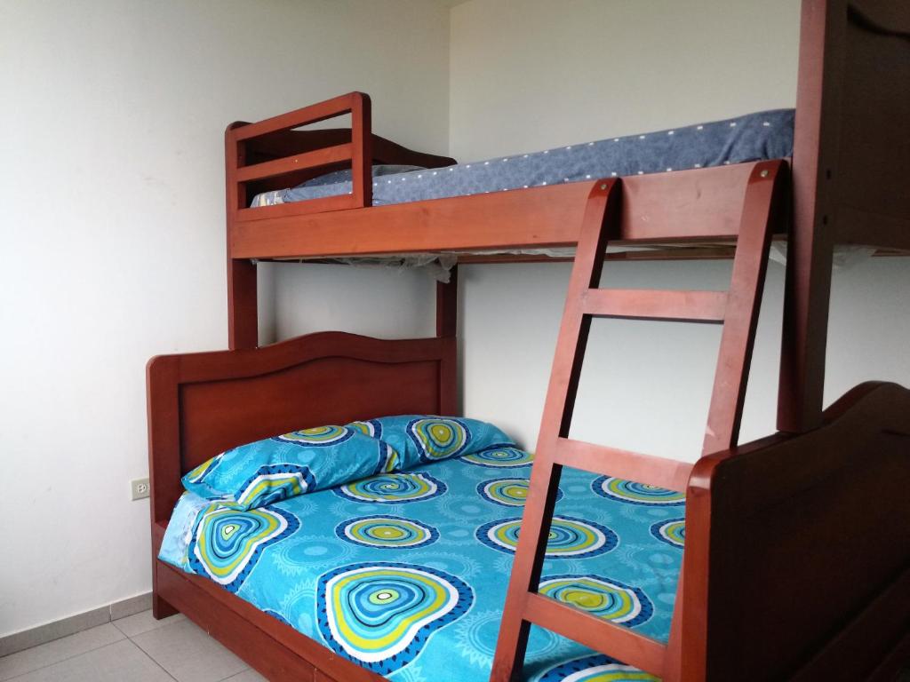 a bedroom with two bunk beds and a ladder at Apartment in Sirenis Atacames in Tonsupa