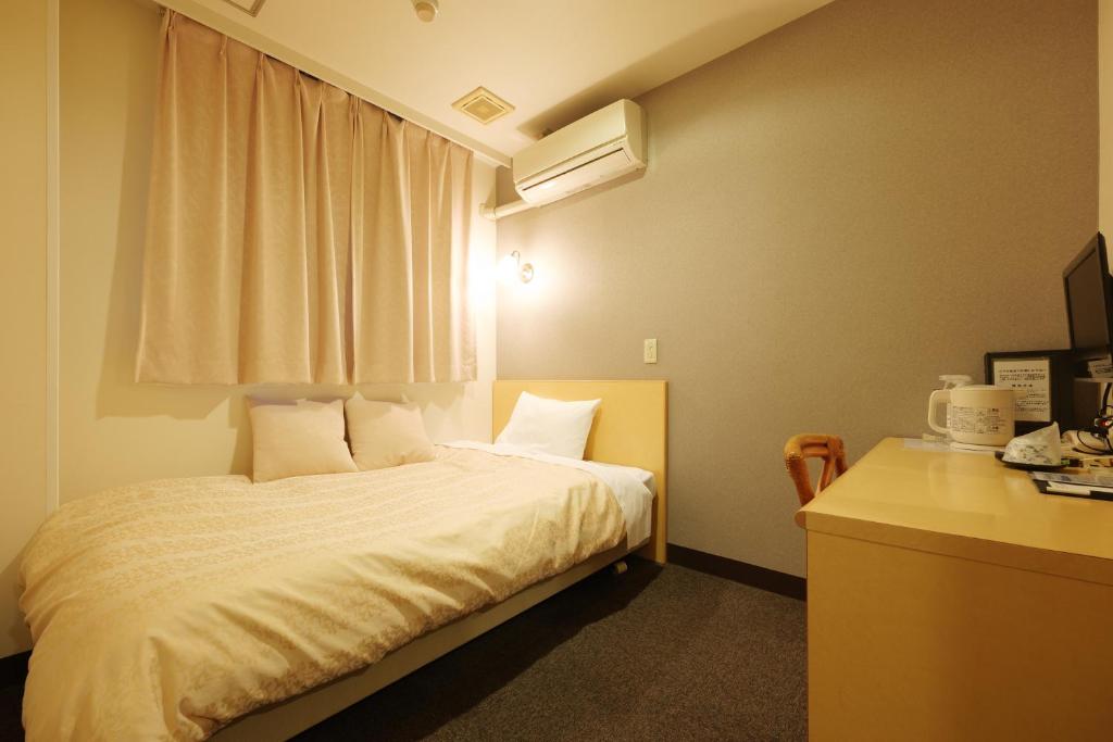 Postel nebo postele na pokoji v ubytování Hotel Suntargas Ueno