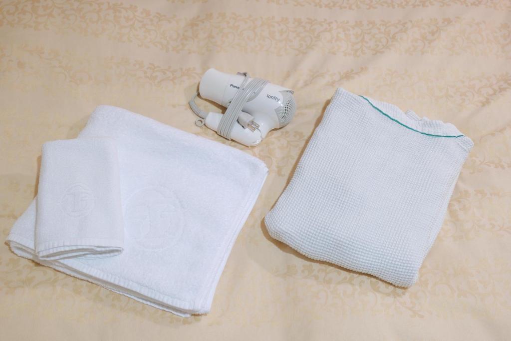 Postel nebo postele na pokoji v ubytování Hotel Suntargas Ueno