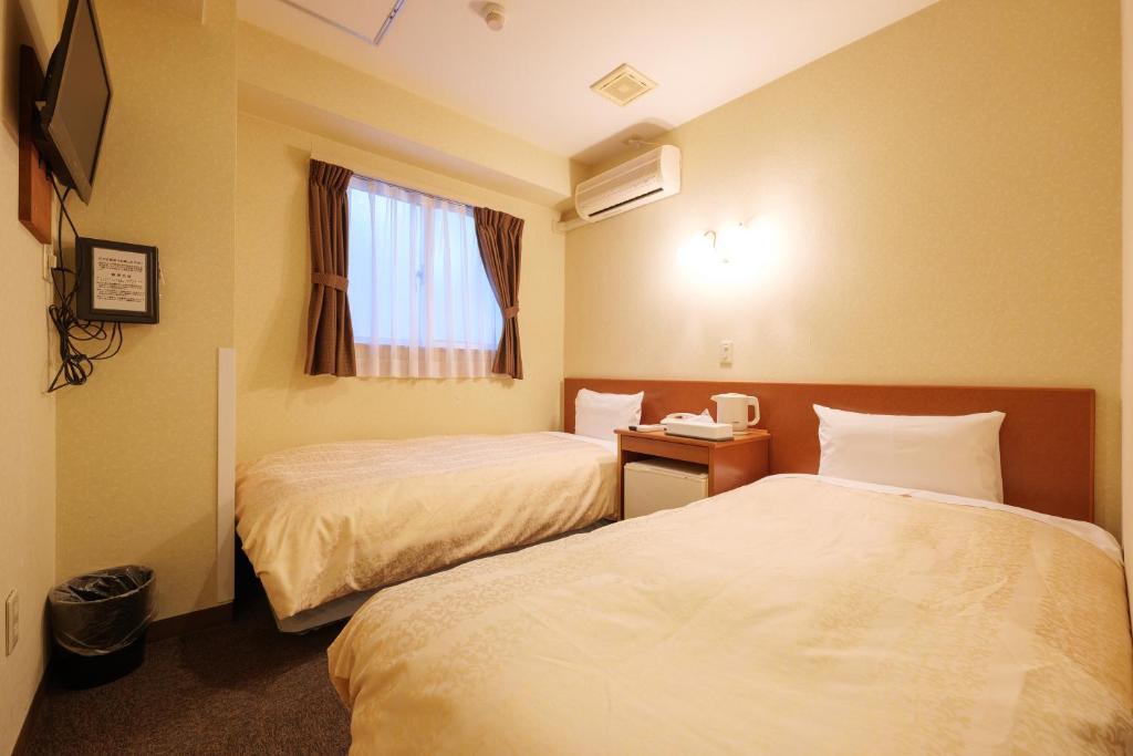 Postel nebo postele na pokoji v ubytování Hotel Suntargas Ueno