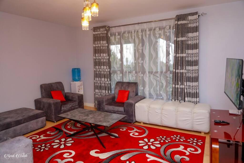 a living room with two chairs and a couch at Luxe Furnished Apartments Unit 9 in Meru