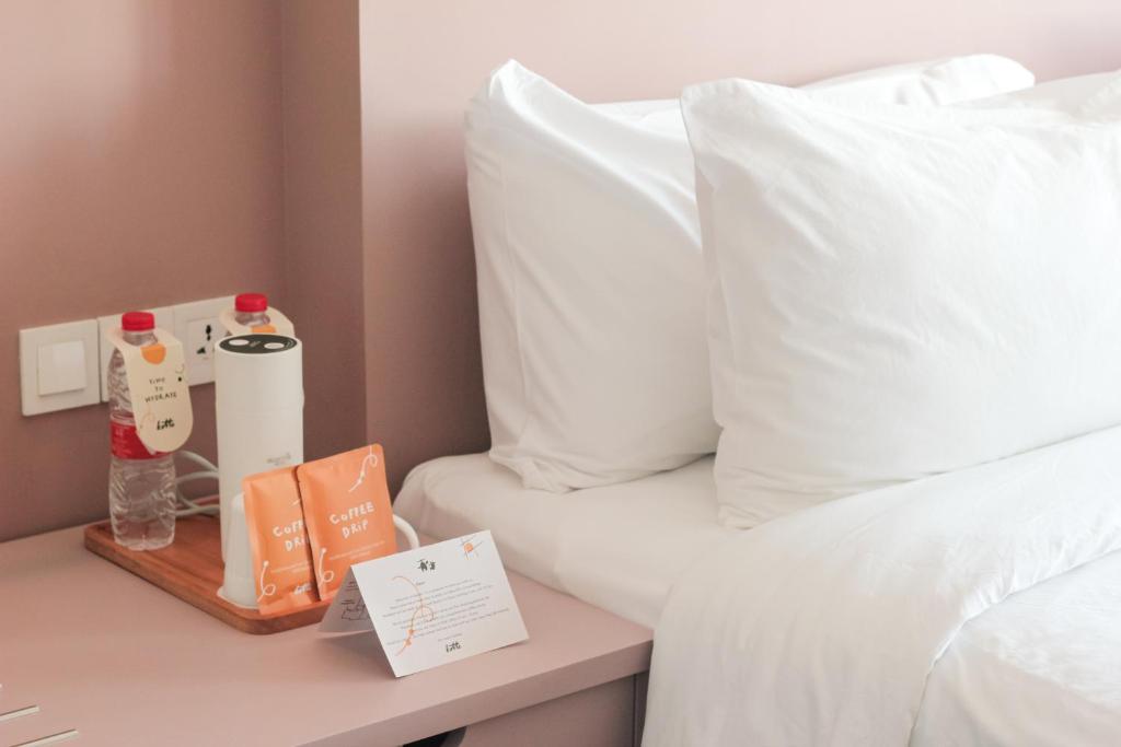 Postel nebo postele na pokoji v ubytování Kotta Hotel Semarang
