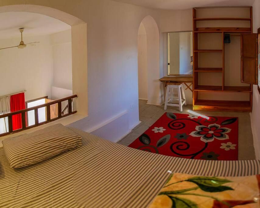 a bedroom with a bed and a room with a table at Abouseif Guest House in Sharm El Sheikh