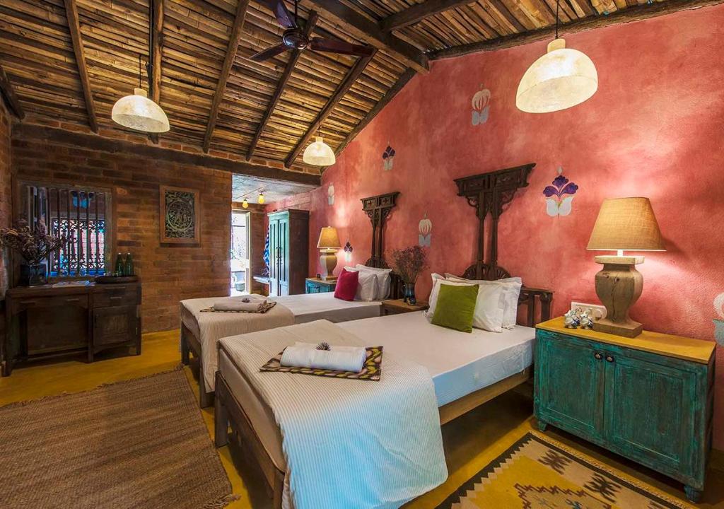 a bedroom with two beds in a room at Turia Villa Canacona Palolem in Canacona