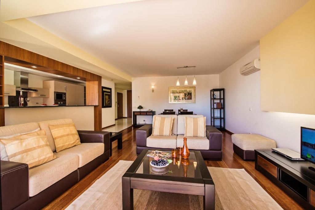a living room with a couch and a table at Baia da Luz Resort in Luz