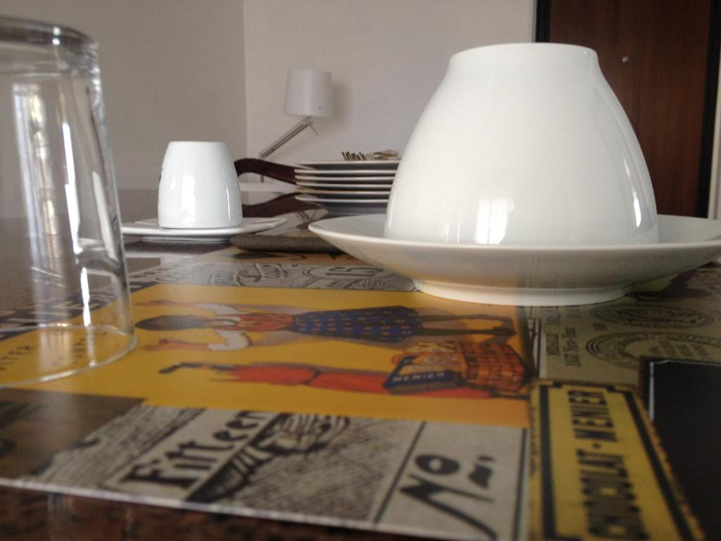 a table with a bowl and a lamp on it at Via Roma suite in Ortona