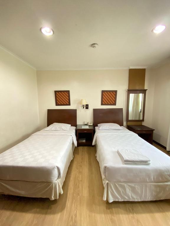 Postel nebo postele na pokoji v ubytování Cipta Hotel Wahid Hasyim