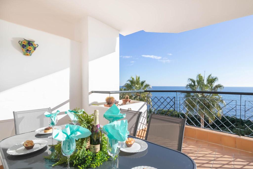 a dining table with a view of the ocean at Mi Capricho beach front sea view & pool - Happy Rentals in Mijas Costa