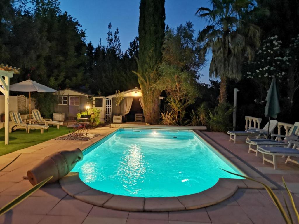 una piscina in un cortile posteriore di notte di Villa Chiara a Magalas