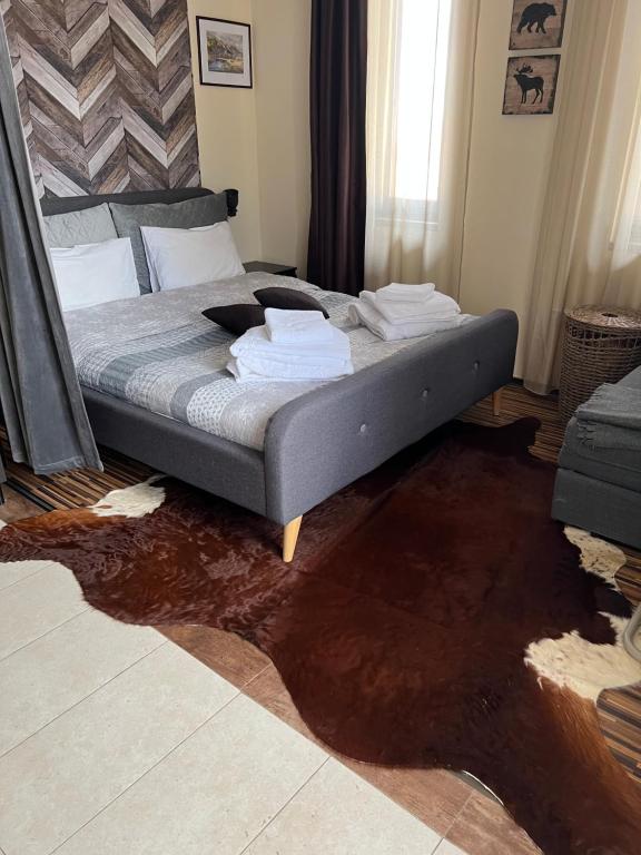 a bed sitting in a room with a spilled at Luxury Studio in Hotel Perun Lodge SPA in Bansko