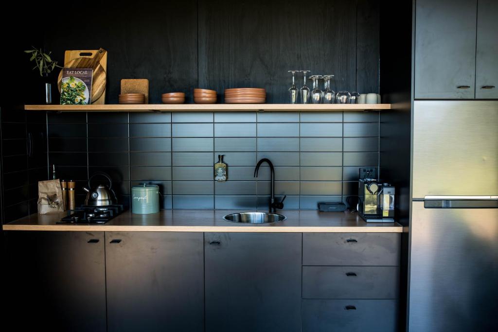 a kitchen with a sink and a counter top at Wander in the Scenic Rim in Wyaralong