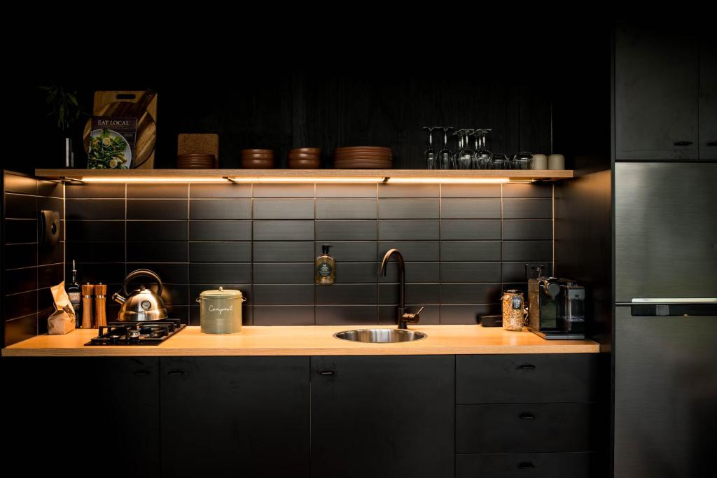 a kitchen with a sink and a counter top at Wander in the Scenic Rim in Wyaralong