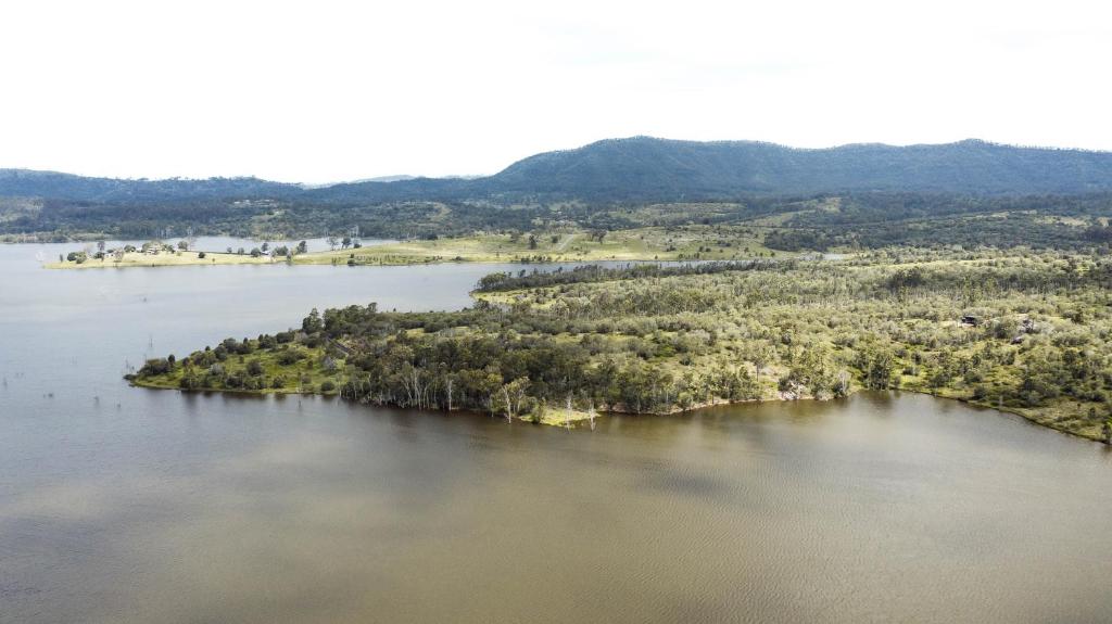 an island in the middle of a body of water at Wander in the Scenic Rim in Wyaralong