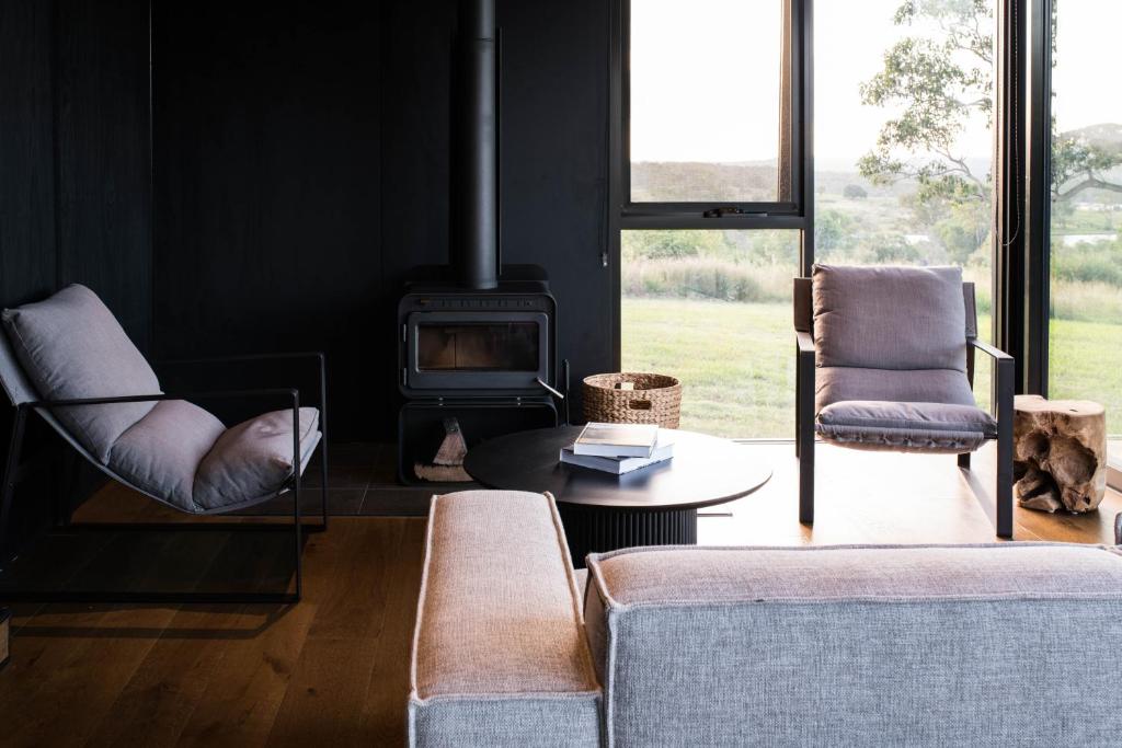 a living room with a couch and a fireplace at Wander in the Scenic Rim in Wyaralong