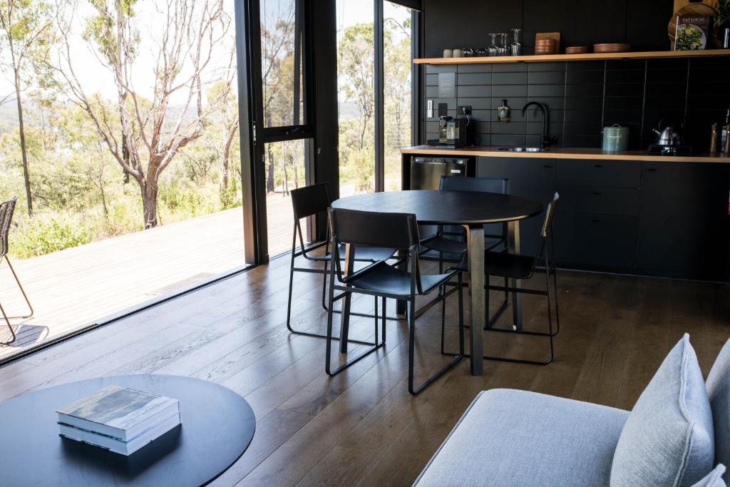 a kitchen with a table and chairs in a room at Wander in the Scenic Rim in Wyaralong