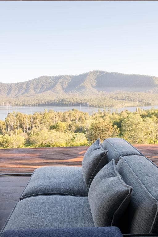 a bedroom with a bed with a view of a mountain at Wander in the Scenic Rim in Wyaralong