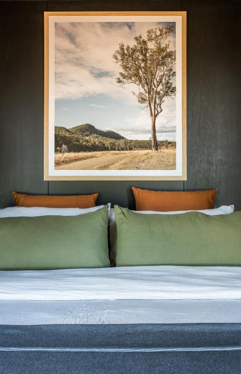 a bedroom with a bed with a tree in the background at Wander in the Scenic Rim in Wyaralong