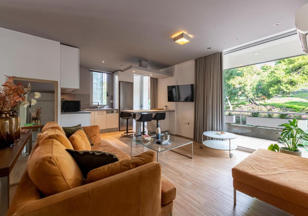 a large living room with a couch and a table at Phaedrus Living: Luxury Flat Vouliagmeni in Athens