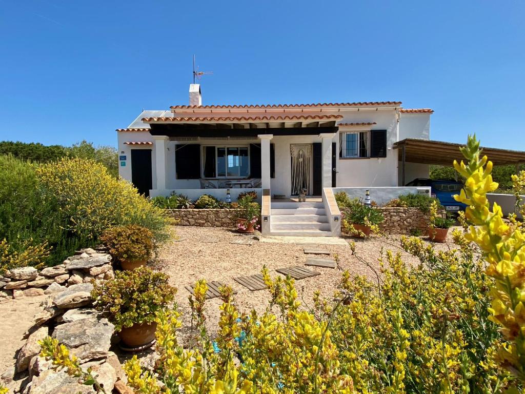 a small white house with a stone yard at Casa Stefi - Astbury Formentera in Es Arenals
