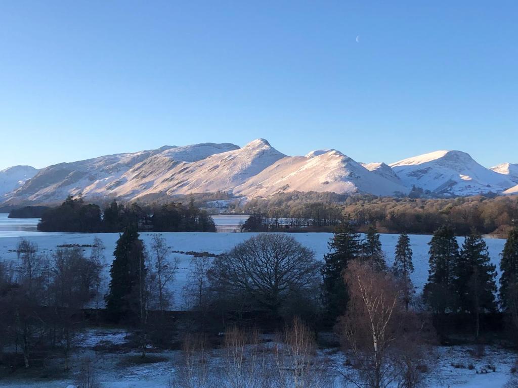 a view of a lake with snow covered mountains at Berkeley House in Keswick