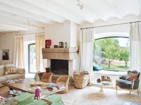 a living room with a couch and a fireplace at Masia Vilatersana in Sant Llorenc Savall