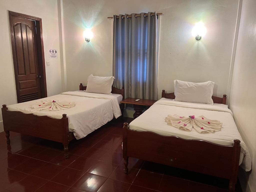 Postel nebo postele na pokoji v ubytování Five Rose Siem Reap Hostel