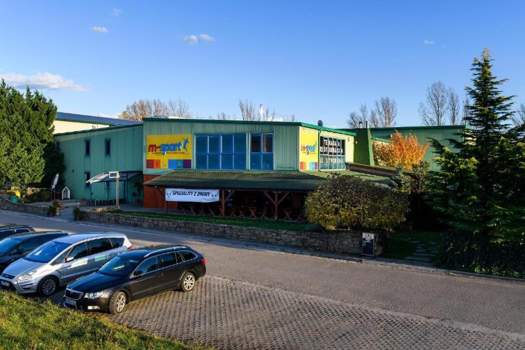 a group of cars parked in front of a building at Penzion MSPORT in Trenčín