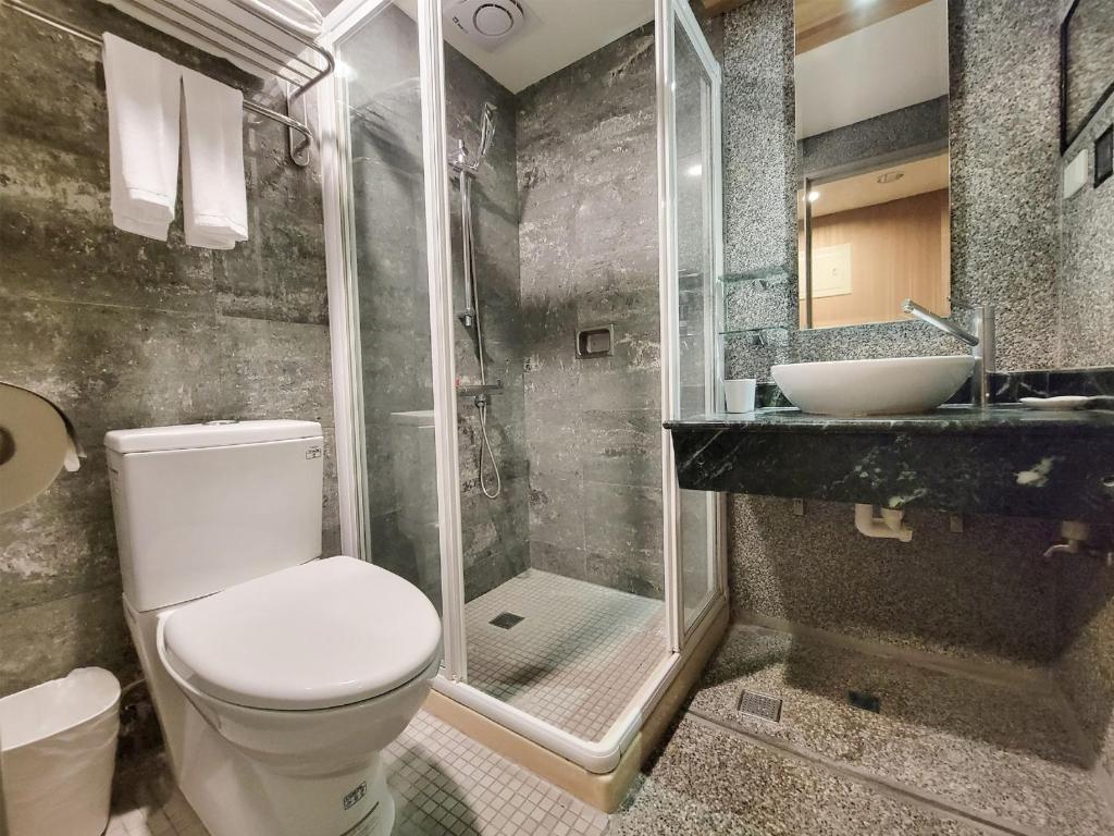 a bathroom with a toilet and a shower and a sink at CHECK inn Express Taichung Fengchia in Taichung