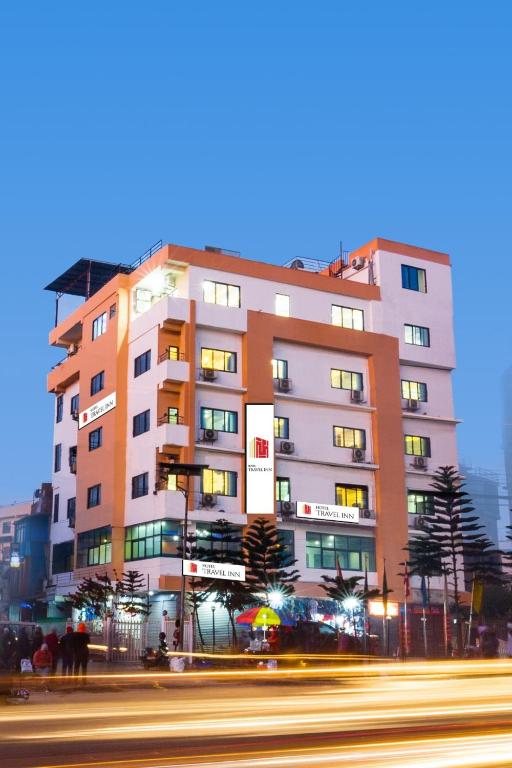 a building on the side of a street with a street at Hotel Travel INN in Kathmandu