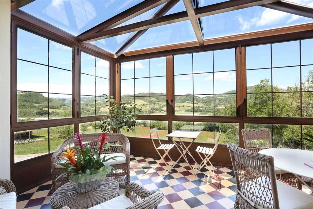 帕爾馬的住宿－Villa Gelsomina，温室配有桌椅和窗户