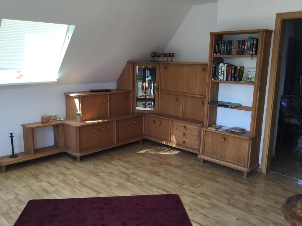 a living room with wooden furniture and a window at Bei Netti in Klütz