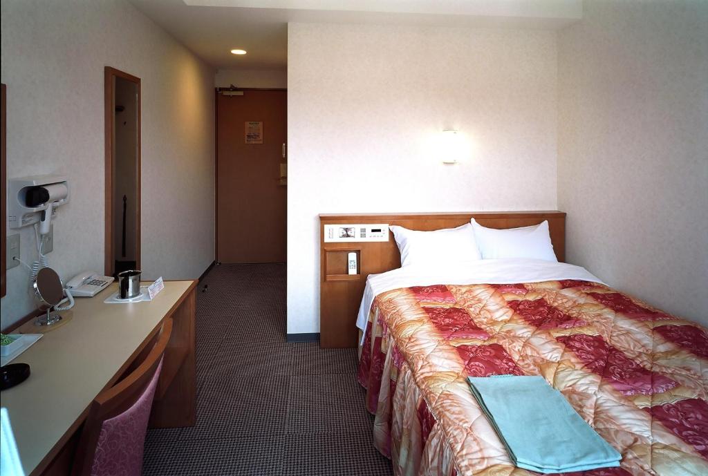 Postel nebo postele na pokoji v ubytování Kochi Ryoma Hotel