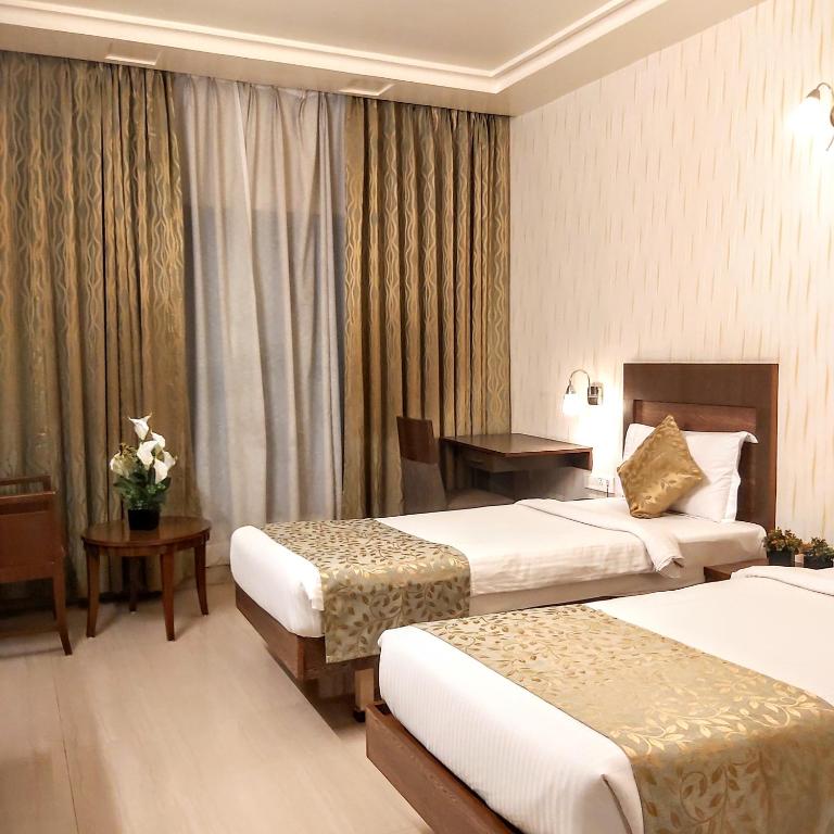 Postel nebo postele na pokoji v ubytování Quality Inn Mint