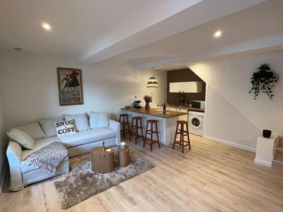 a living room with a couch and a table at Suite cosy au cœur de Vinzelles proche Mâcon Tout équipé avec salon d'extérieur in Vinzelles