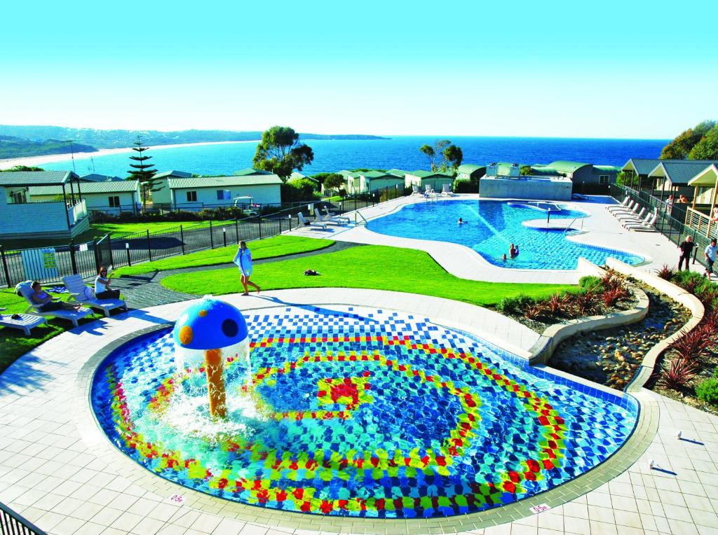 a large fountain sitting in the middle of a pool at NRMA Merimbula Beach Holiday Resort in Merimbula