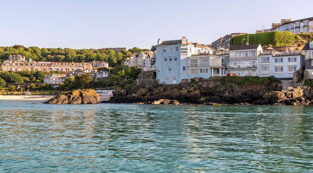 a view of a city from the water with houses at Pedn-Olva in St Ives