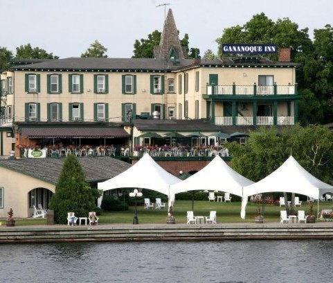 a hotel with white tents in front of a building at The Gananoque Inn & Spa in Gananoque