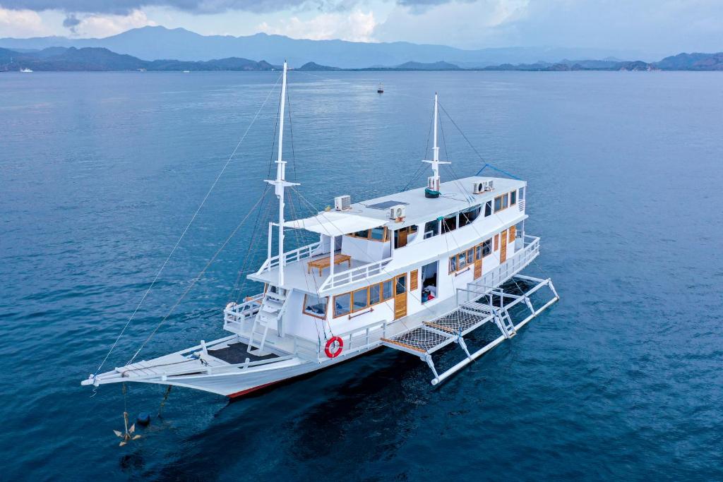 a white boat in the middle of the water at Open trip Labuan Bajo in Labuan Bajo