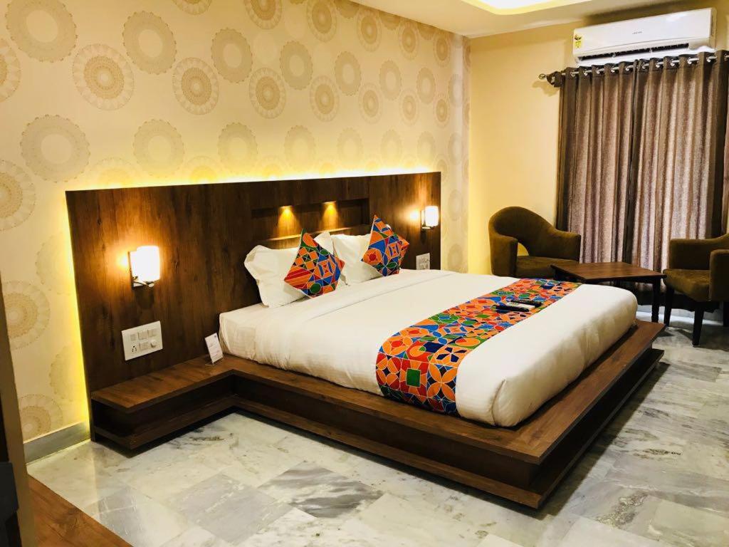 a bedroom with a large bed in a room at HOTEL DAMANIS in Udaipur