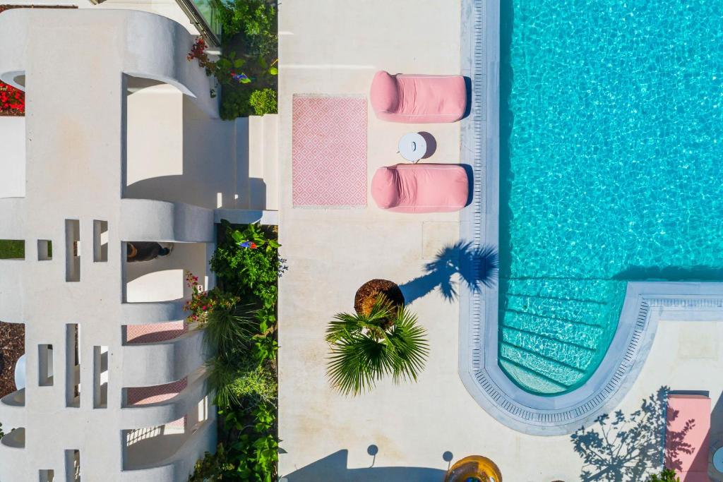 an overhead view of a swimming pool and a resort at Cocoοns Suites & Villas Fourka in Fourka