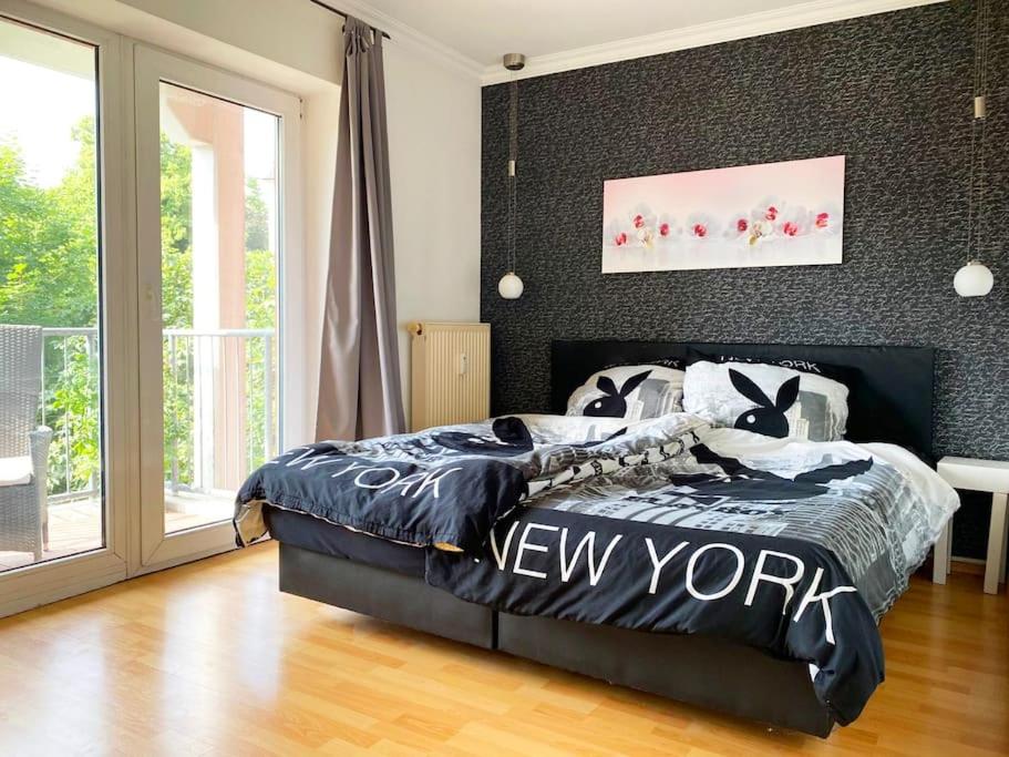 a bedroom with a bed with a black and white comforter at 4 Zimmer Wohnung mit 6 Betten nahe Hamburg in Glinde